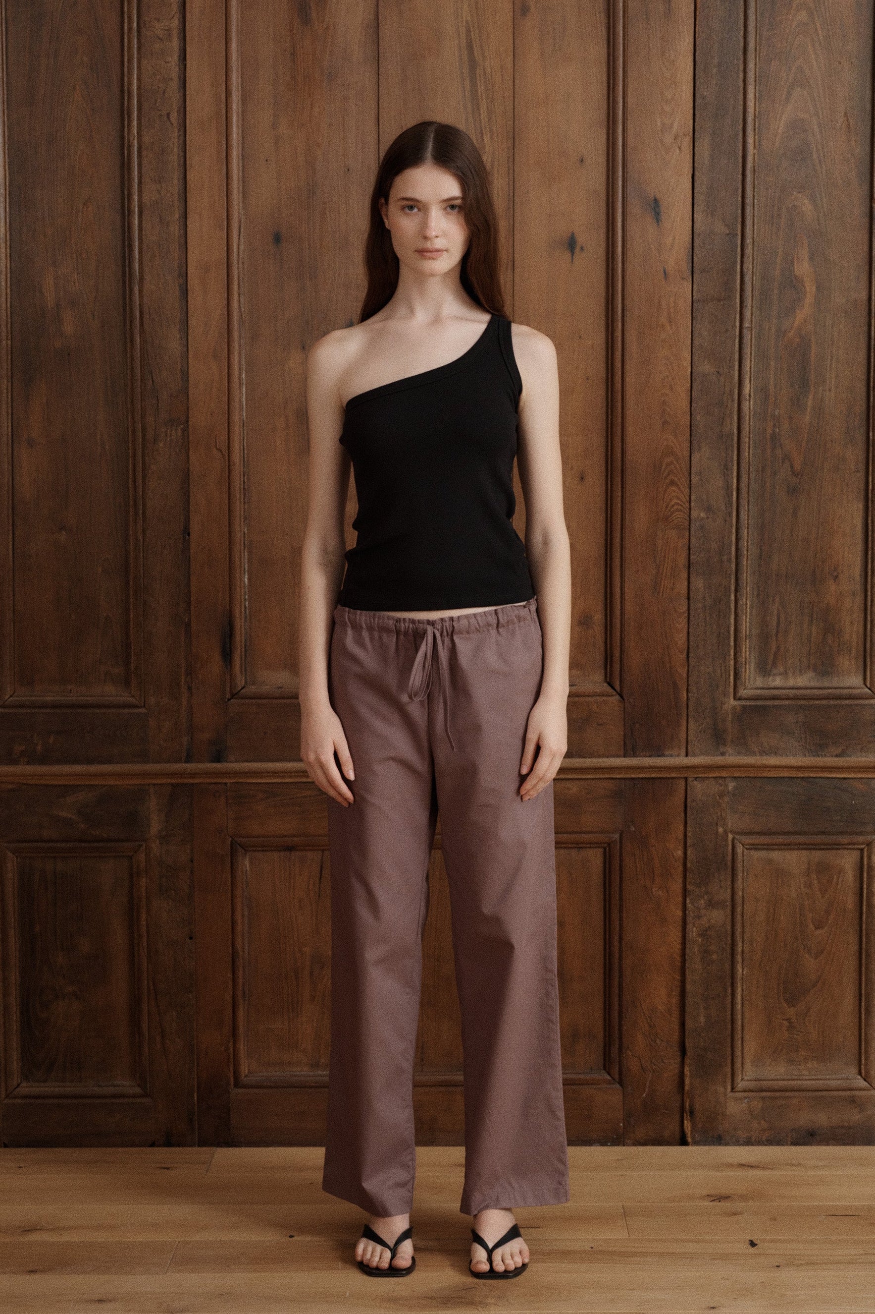 Minimalist black one-shoulder tank with an asymmetrical neckline and sleek fitted shape. - VIR VITA
#color_Black