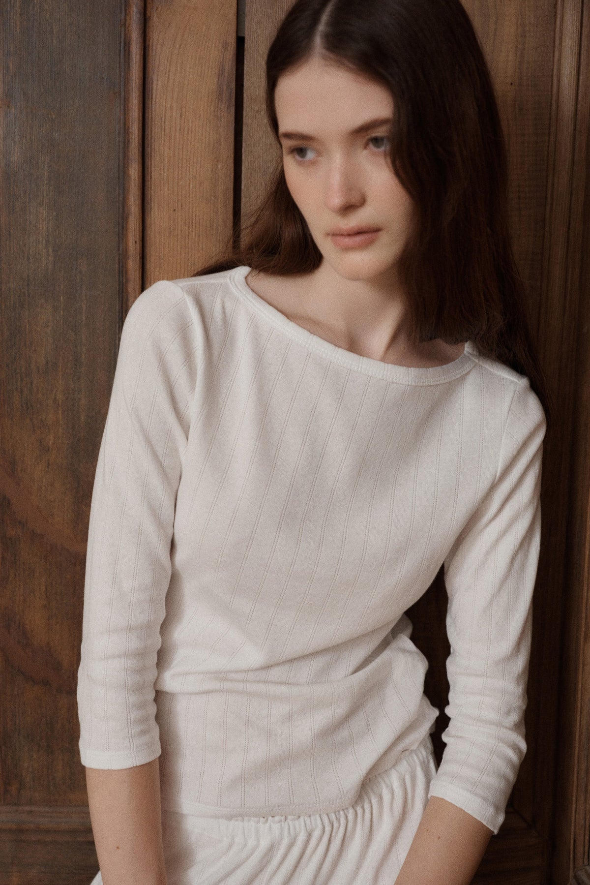 Female model posing wearing a 100% cotton boatneck pointelle three-quarter sleeve top in white paired with matching elastic waist lounge pants. - VIR VITA
#color_coconut