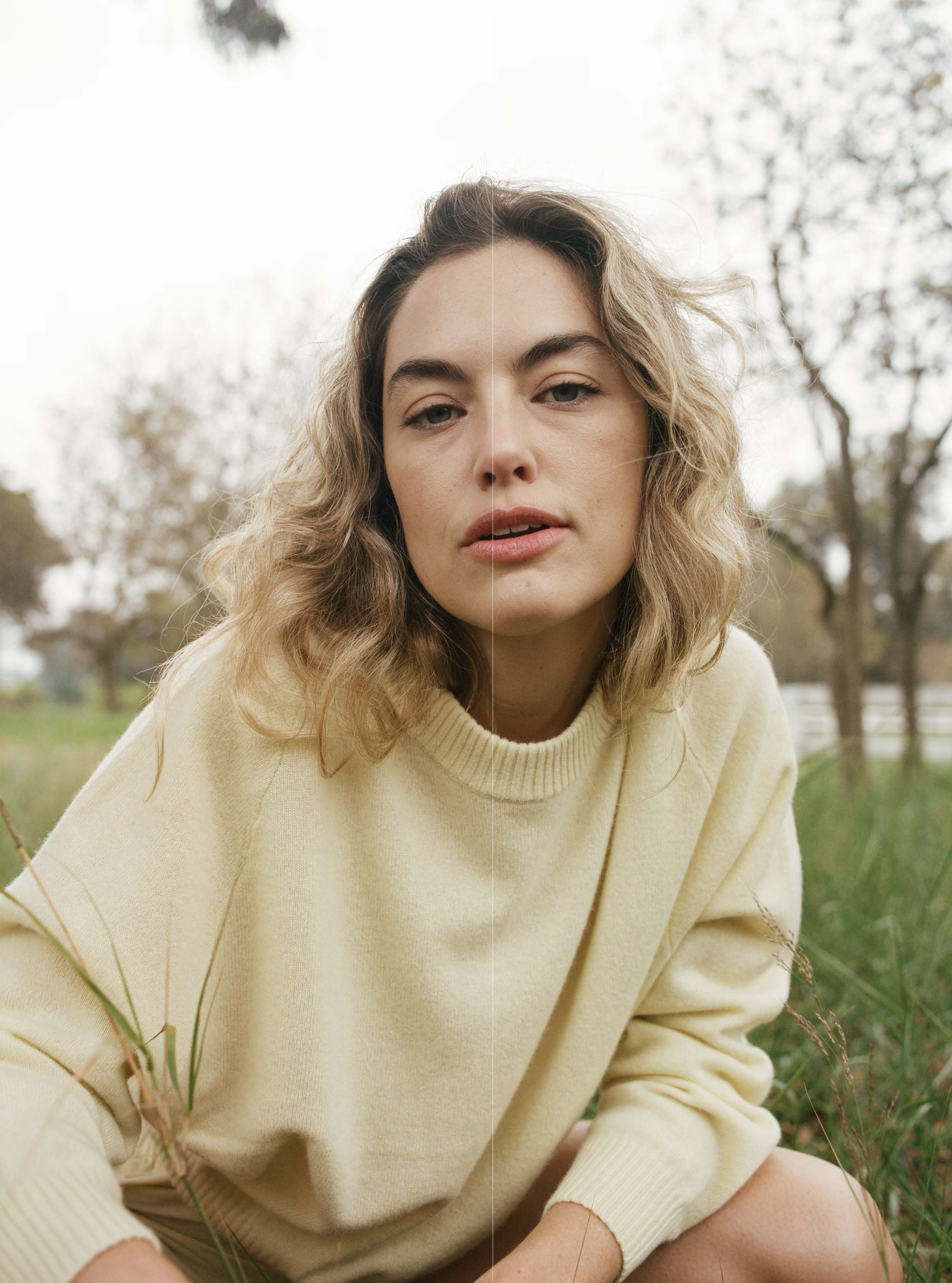 Female model in a field wearing a pale yellow luxurious and soft cashmere pullover sweater with a classic and relaxed silhouette - VIR VITA
#color_butter
