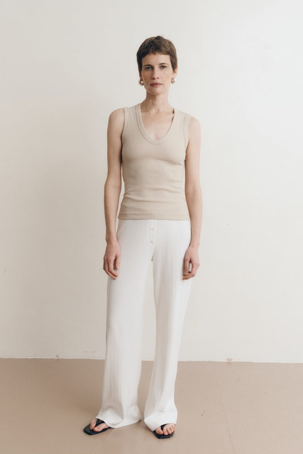 Ribbed Supima cotton tank top in dune, deep scoop neckline, worn by model #color_dune