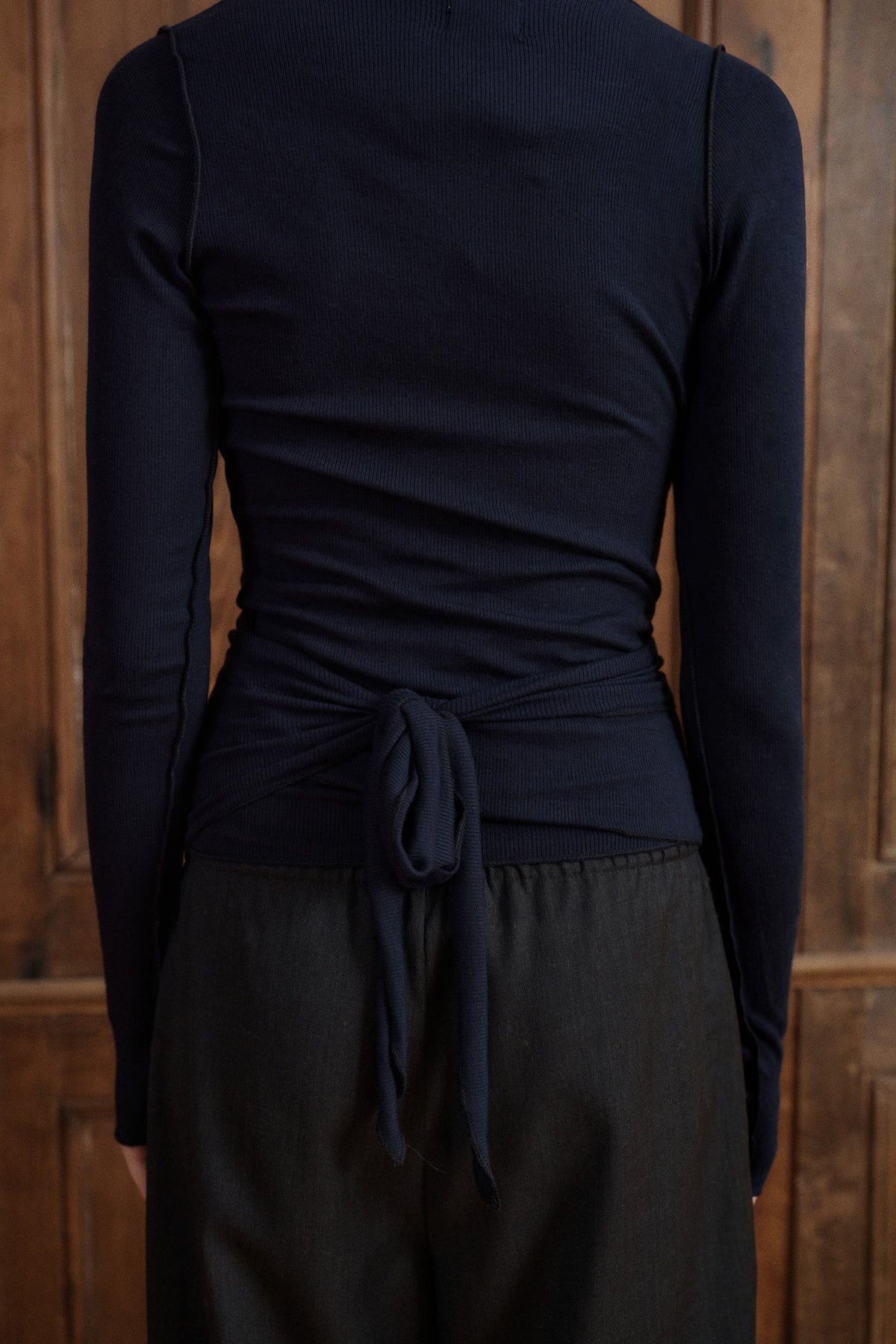 Women’s navy V-neck wrap top with a close-to-body silhouette and delicate waist tie. - VIR VITA
#color_midnight