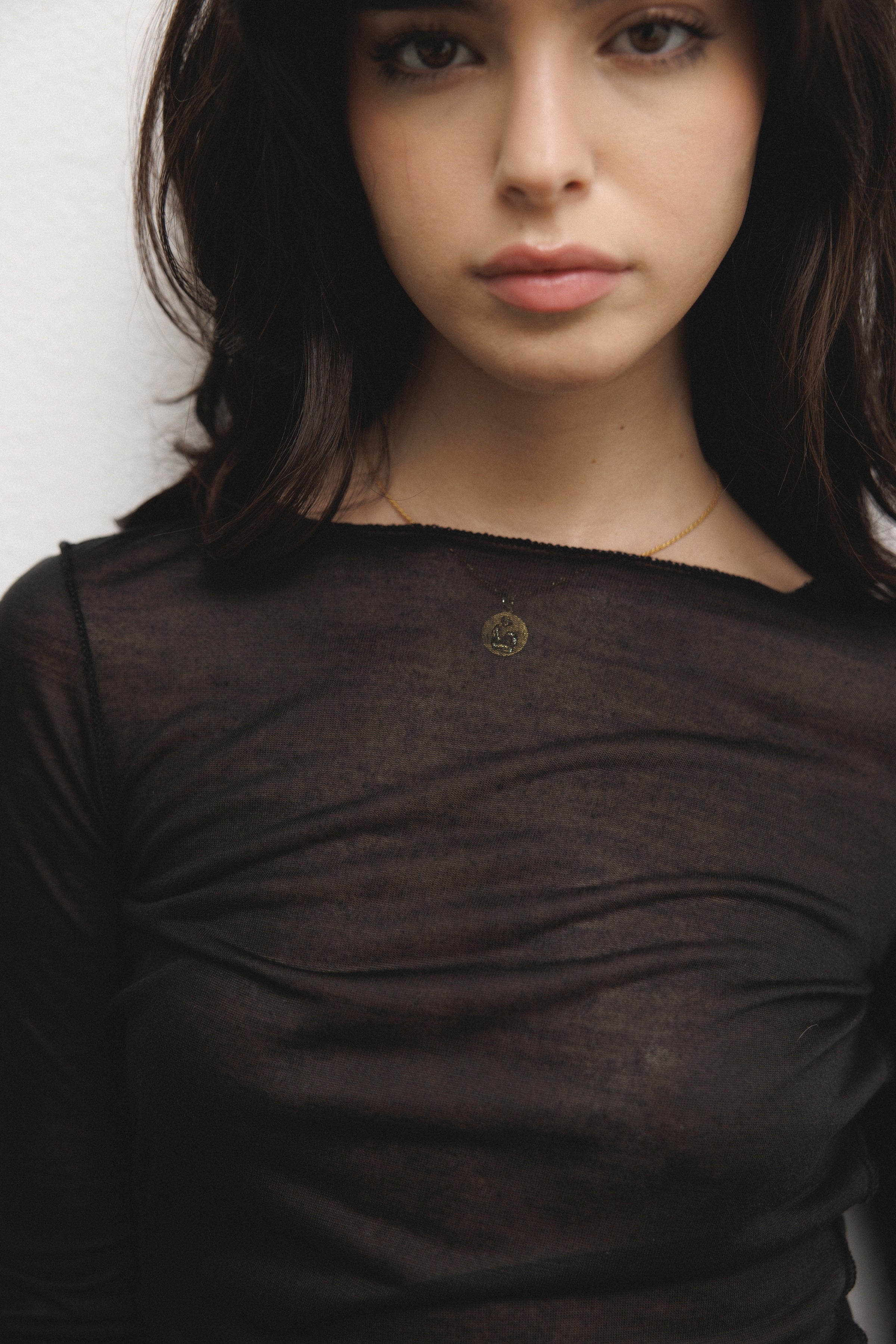 Female model wearing a luxurious lightweight black modal silk long sleeve knit with a ribbed back- VIR VITA
#color_black