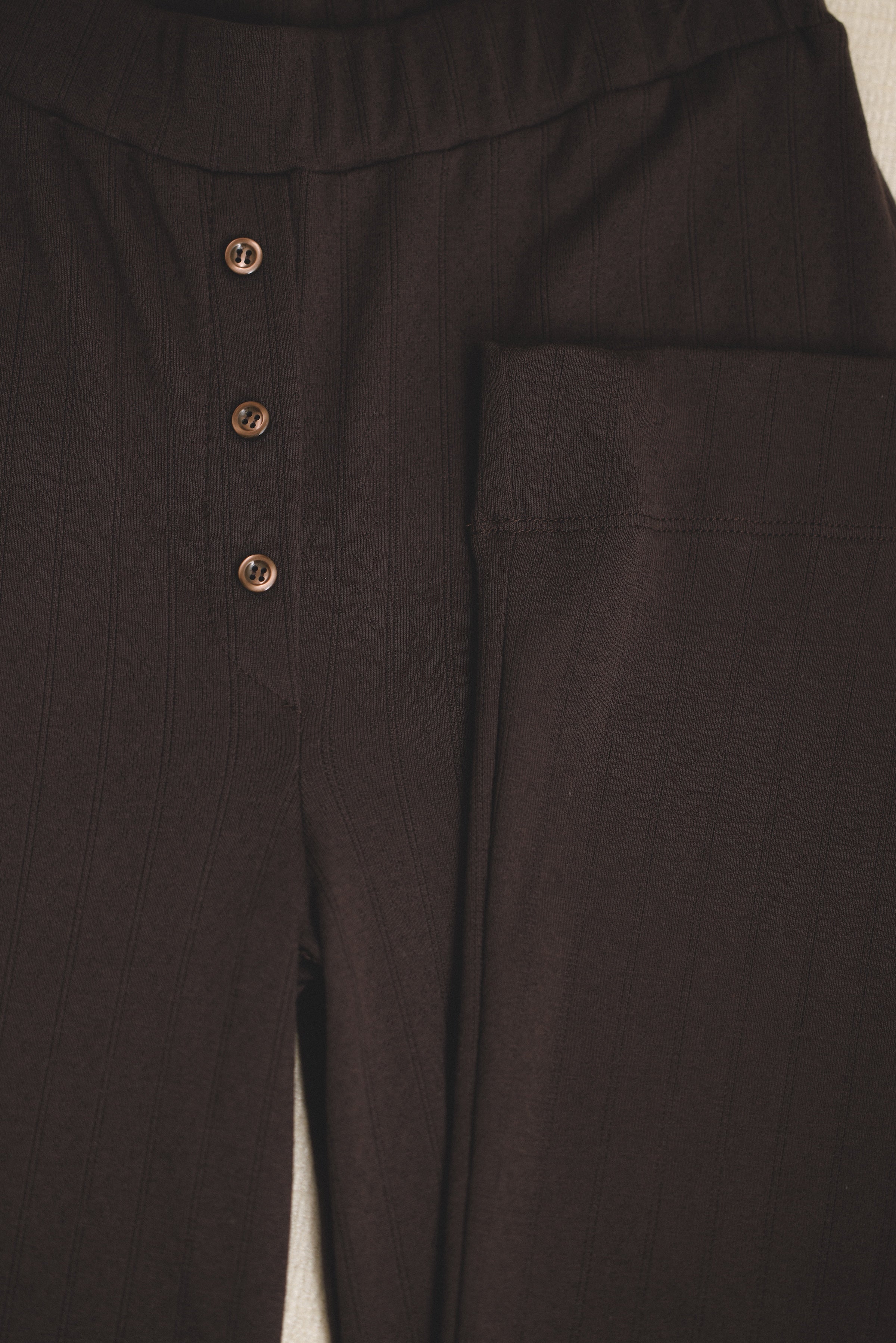 Sustainable dark brown pointelle luxury lounge pant featuring a relaxed straight leg fit with matching brown italian buttons - VIR VITA
#color_espresso