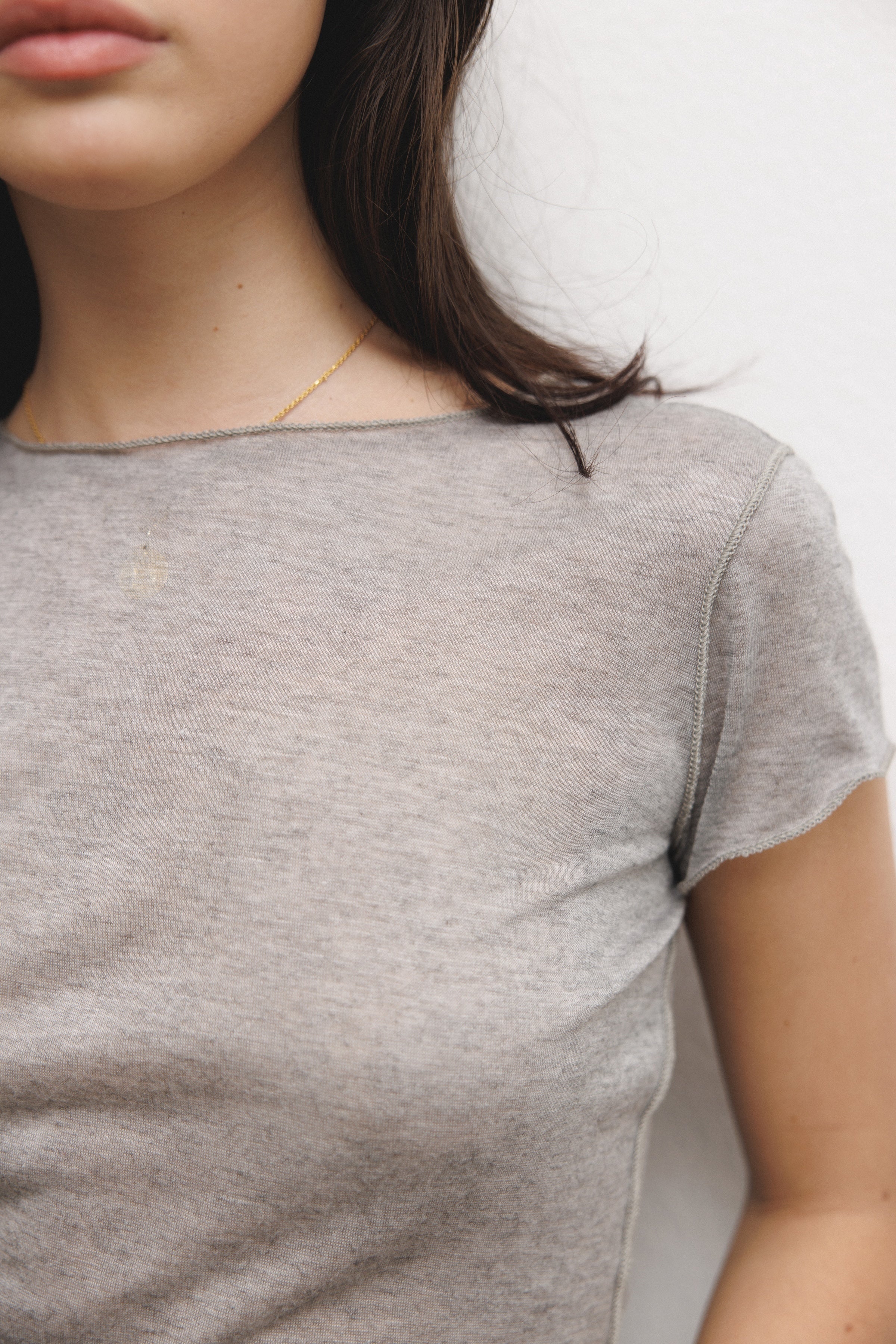 Female model wearing a luxurious lightweight heather grey modal silk short sleeve knit top with a ribbed back- VIR VITA
#color_heather grey