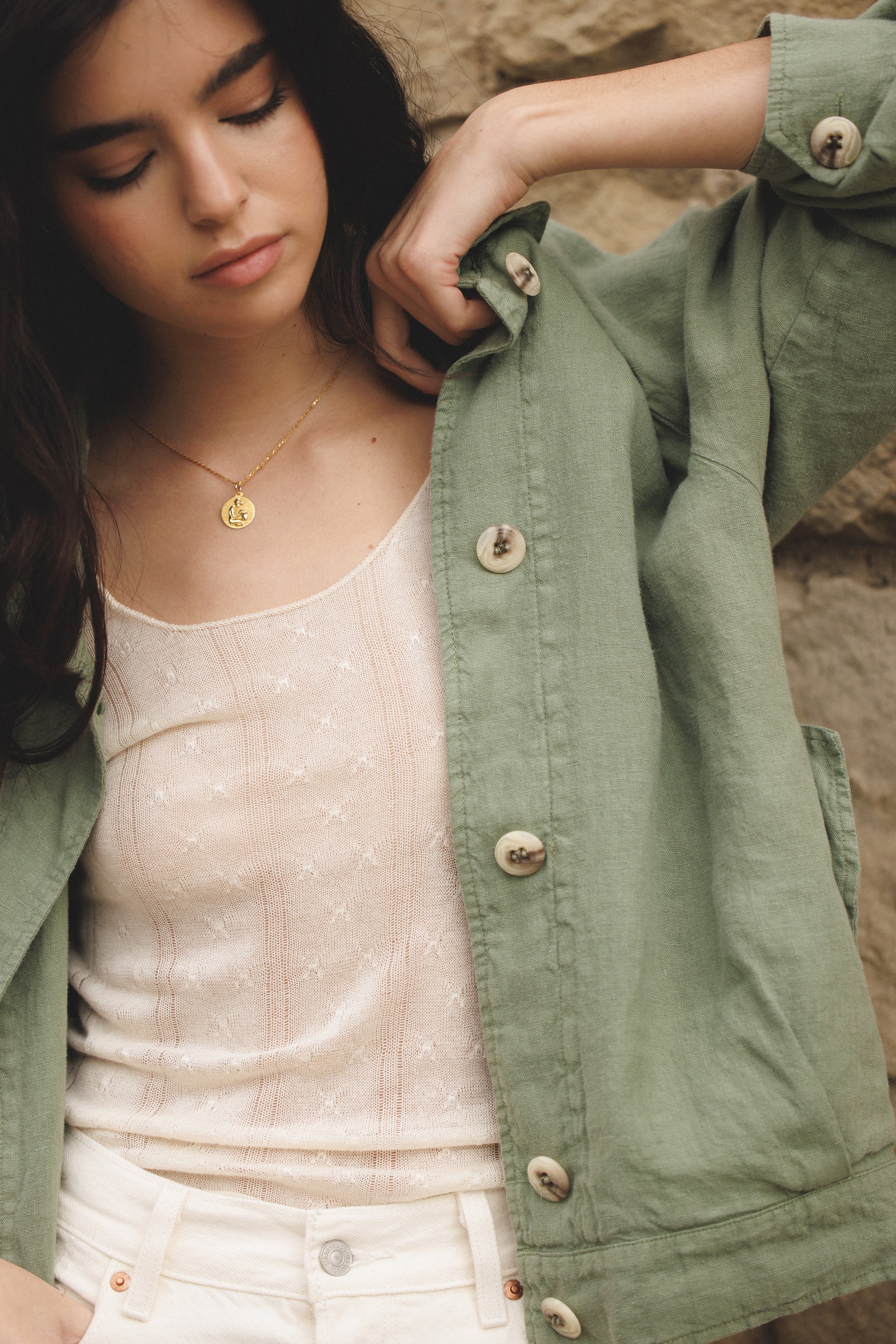Female model wearing sustainable sage green 100% linen barn jacket with white jeans and a white cashmere top - VIR VITA
#color_sage