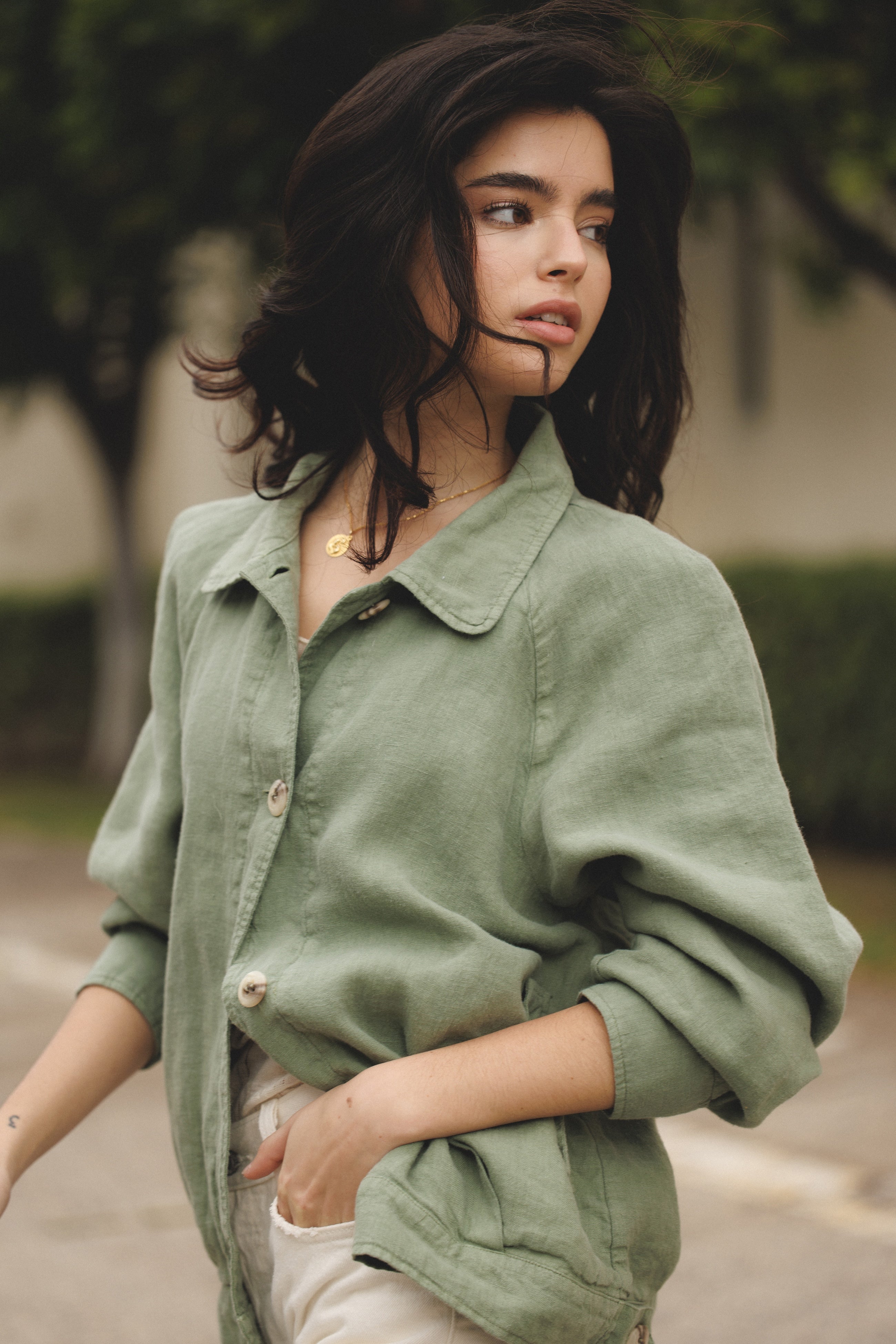 Female model wearing sustainable sage green 100% linen barn jacket with white jeans - VIR VITA
#color_sage