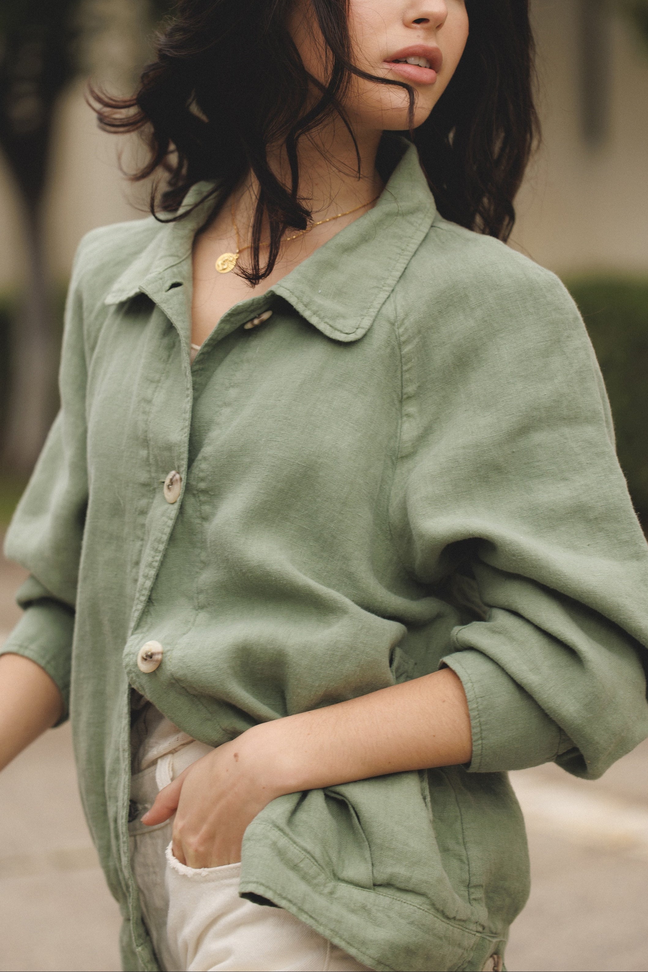 Female model wearing sustainable sage green 100% linen barn jacket with white jeans - VIR VITA
#color_sage