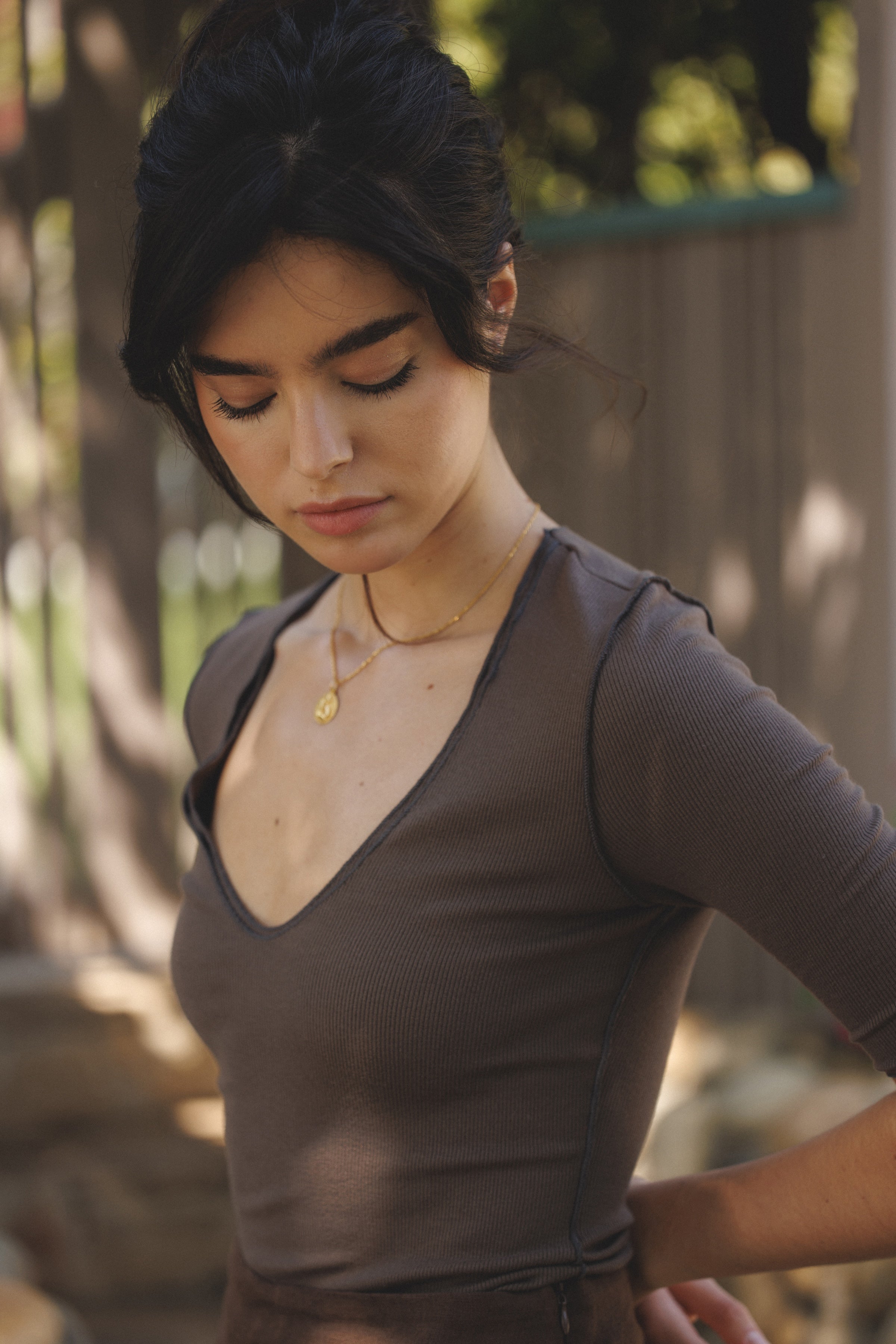 Female model wearing micro modal dark brown three-quarter sleeve v-neck top paired with a dark brown linen mini skirt. Classic, timeless, elegant, french style. - VIR VITA
#color_chestnut