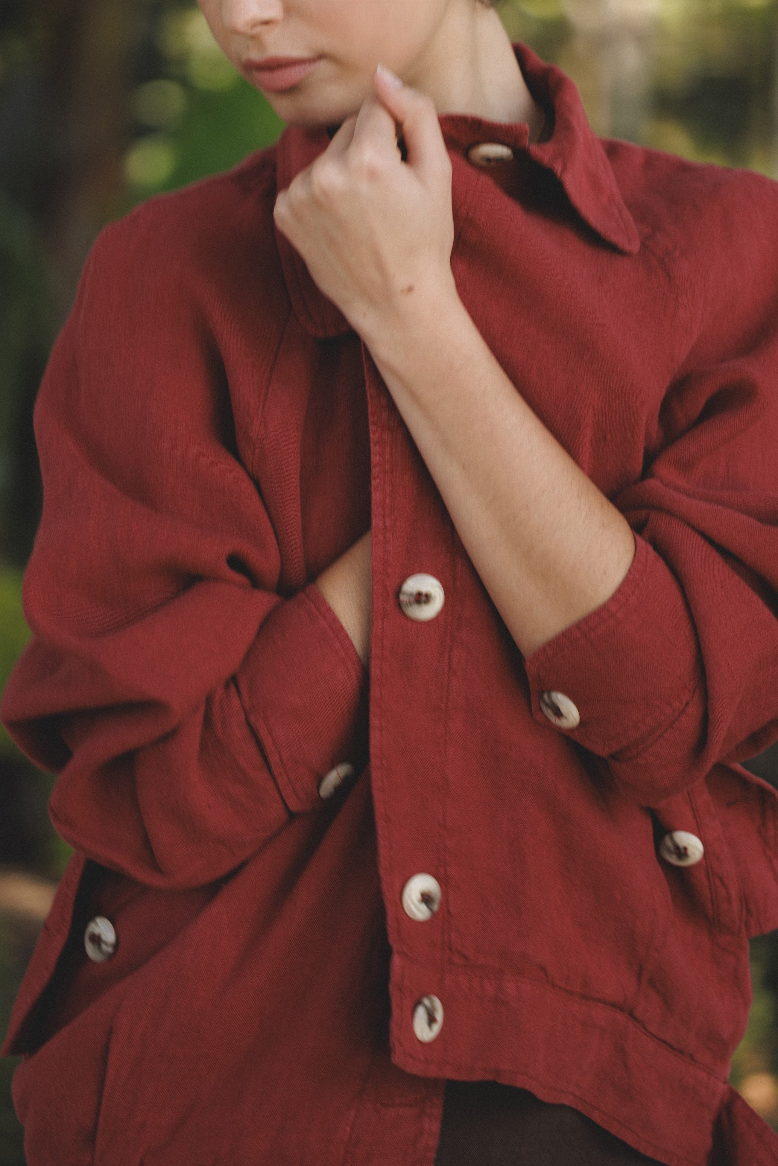 Female model wearing sustainable burgundy red 100% linen barn jacket with brown linen mini skirt - VIR VITA
#color_sun dried tomato