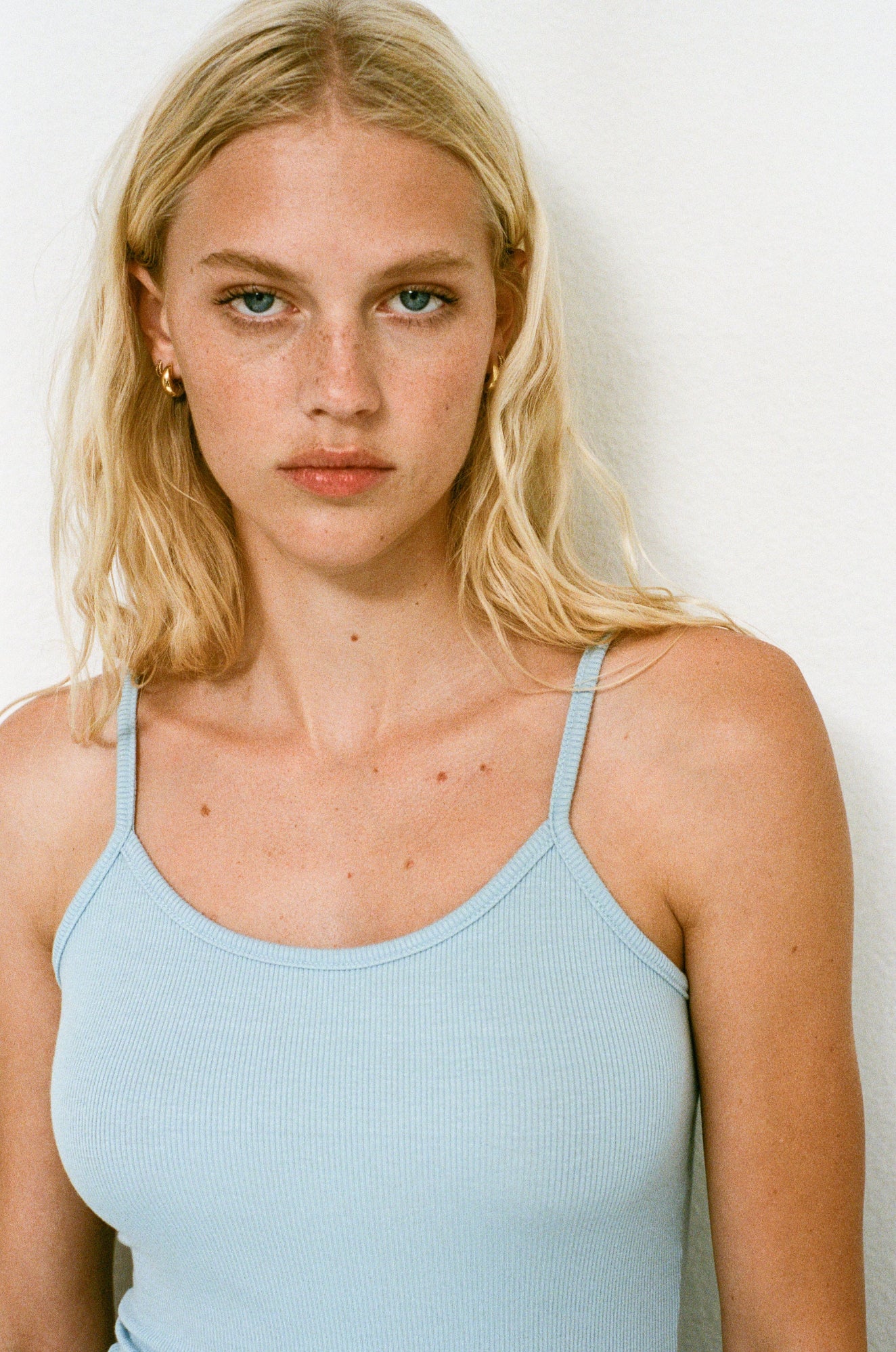 Female model wearing a sustainable classic scoop neck camisole tank top in light blue - VIR VITA
#color_baby blue