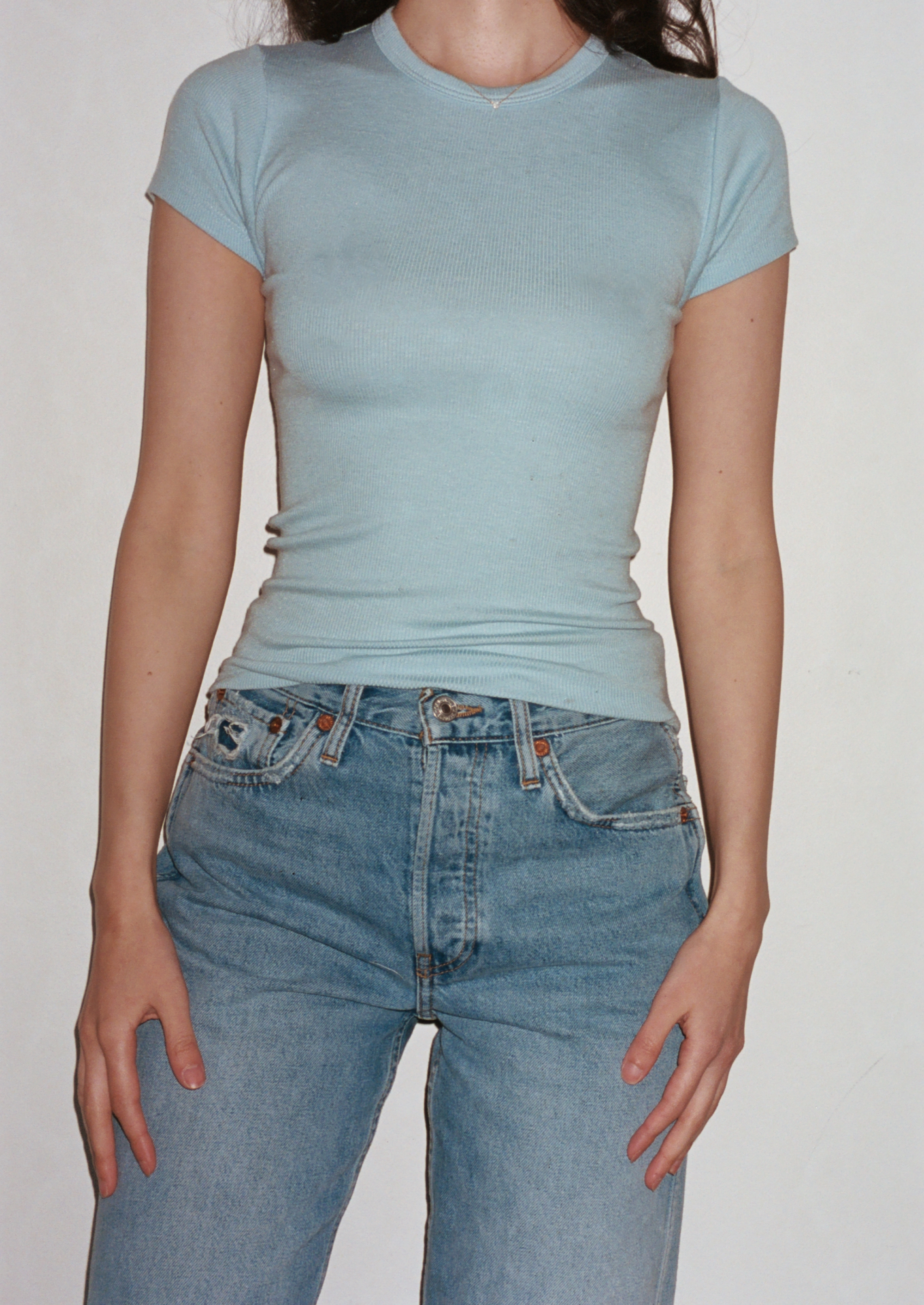 Female model wearing a sustainable baby blue fitted tee- VIR VITA
#color_baby blue