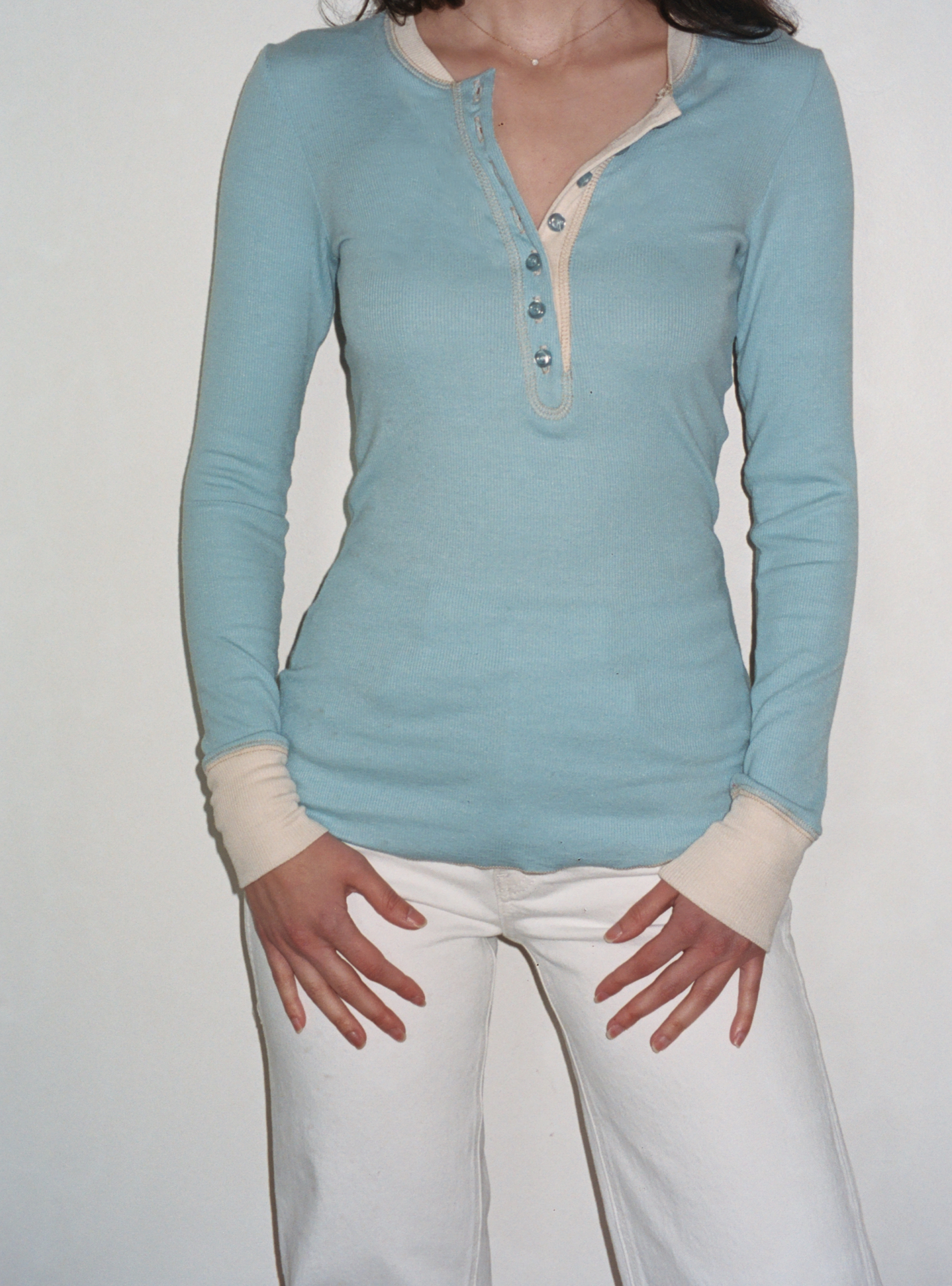 Female model wearing baby blue sustainable micro modal long sleeve henley top with italian button detailing. Classic, timeless, elegant, french style. Natural organic clothing - VIR VITA

#color_baby blue