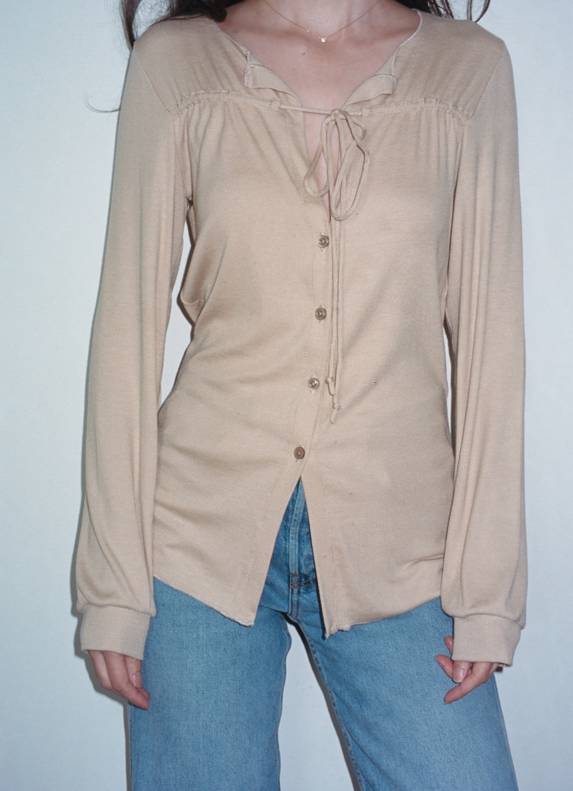 Female model wearing sustainable micro modal cream buttery soft long sleeve ribbed top with tie and italian button. Romantic top. Classic, timeless, elegant, french style. natural organic clothing- VIR VITA

#color_toffee