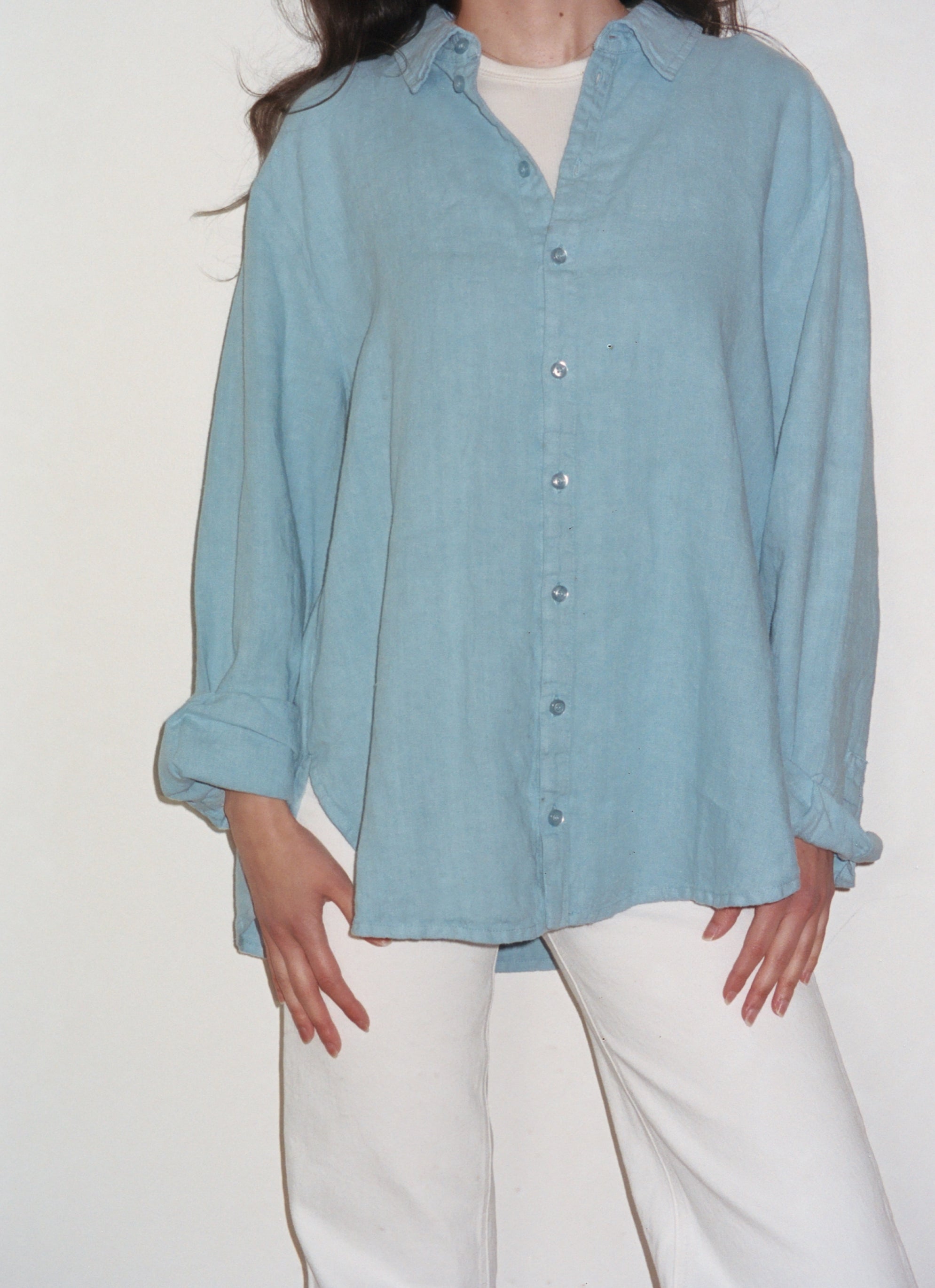 Female model wearing a baby blue sustainable oversized linen button down long sleeve - VIR VITA
#color_baby blue