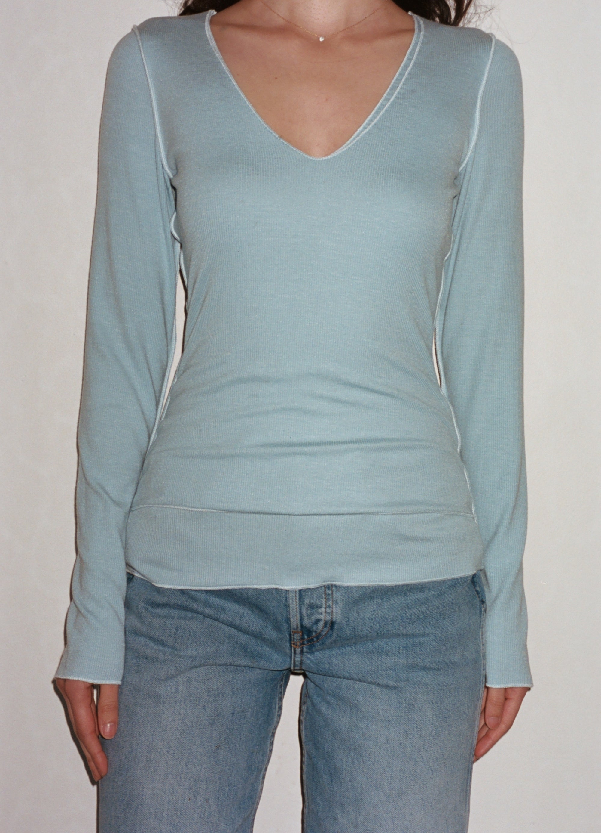 Female model wearing sustainable micro modal baby blue buttery soft double lined v neck long sleeve ribbed top. Classic, timeless, elegant, french style. natural organic clothing- VIR VITA
#color_baby blue