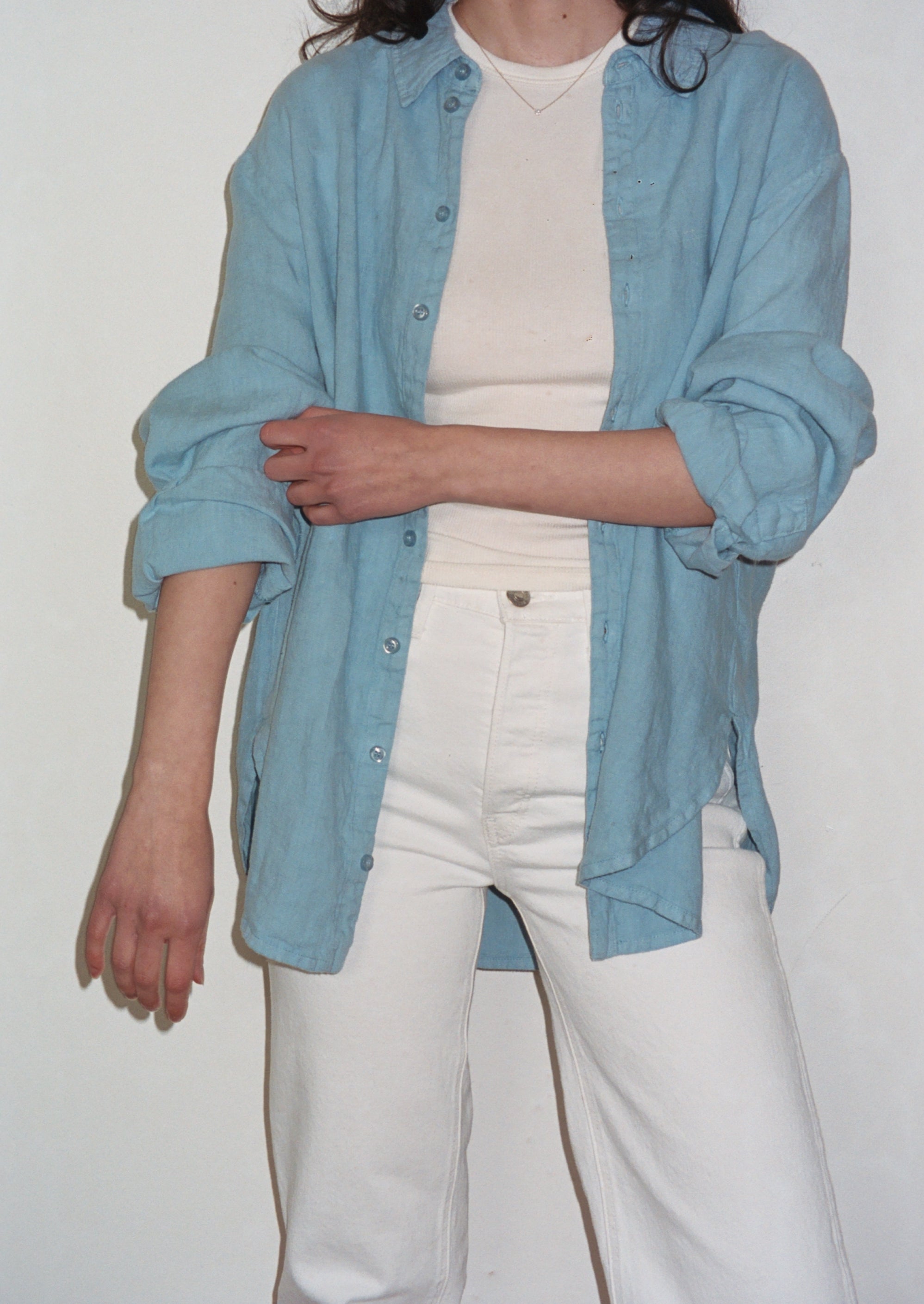 Female model wearing a baby blue sustainable oversized linen button down long sleeve - VIR VITA
#color_baby blue