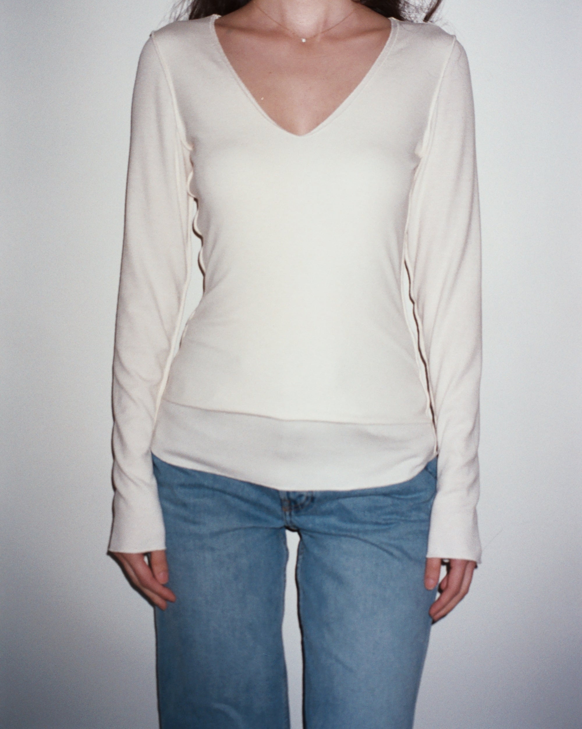 Female model wearing sustainable micro modal white buttery soft double lined v neck long sleeve ribbed top. Classic, timeless, elegant, french style. natural organic clothing- VIR VITA

#color_coconut