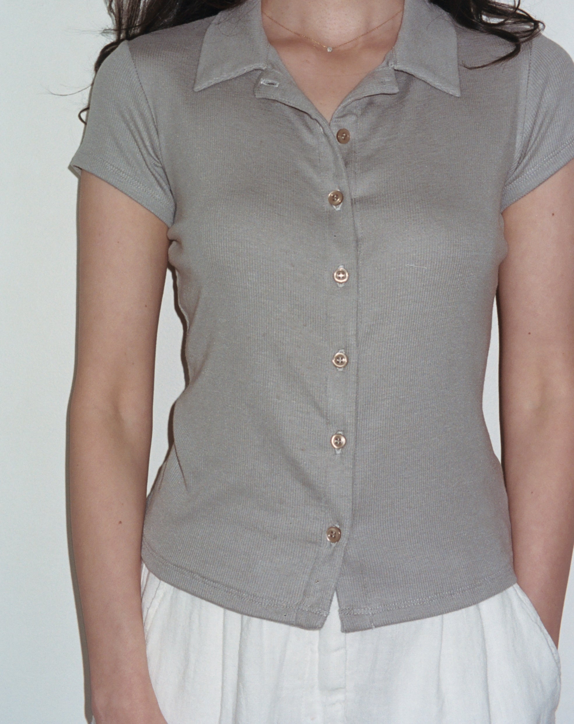 Female model wearing grey sustainable micro modal short sleeve ribbed polo top with italian button detailing. Classic, timeless, elegant, french style. Natural organic clothing - VIR VITA


#color_grey