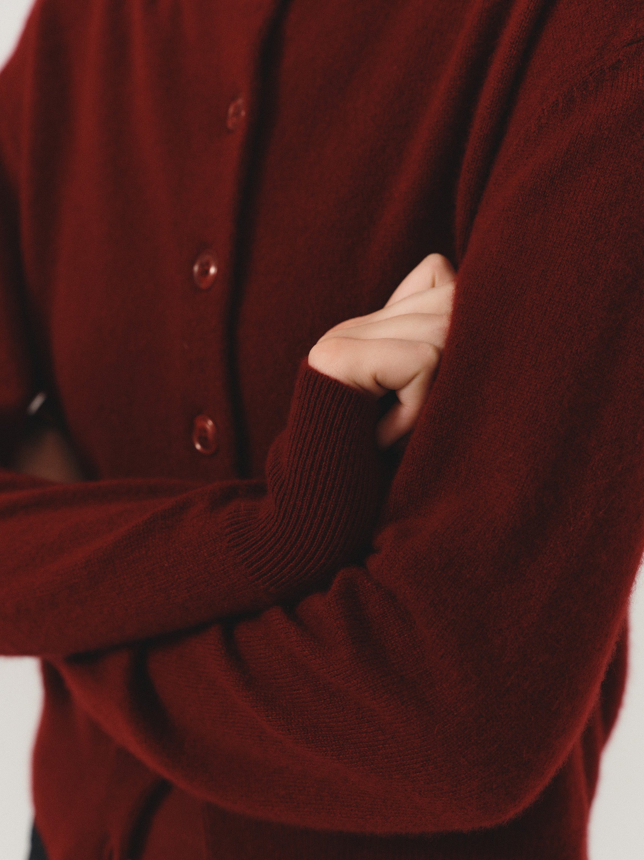 A soft everyday knit designed with a round neckline, tonal button closure, long sleeves, and ribbed cuffs and hem. - VIR VITA
#color_merlot