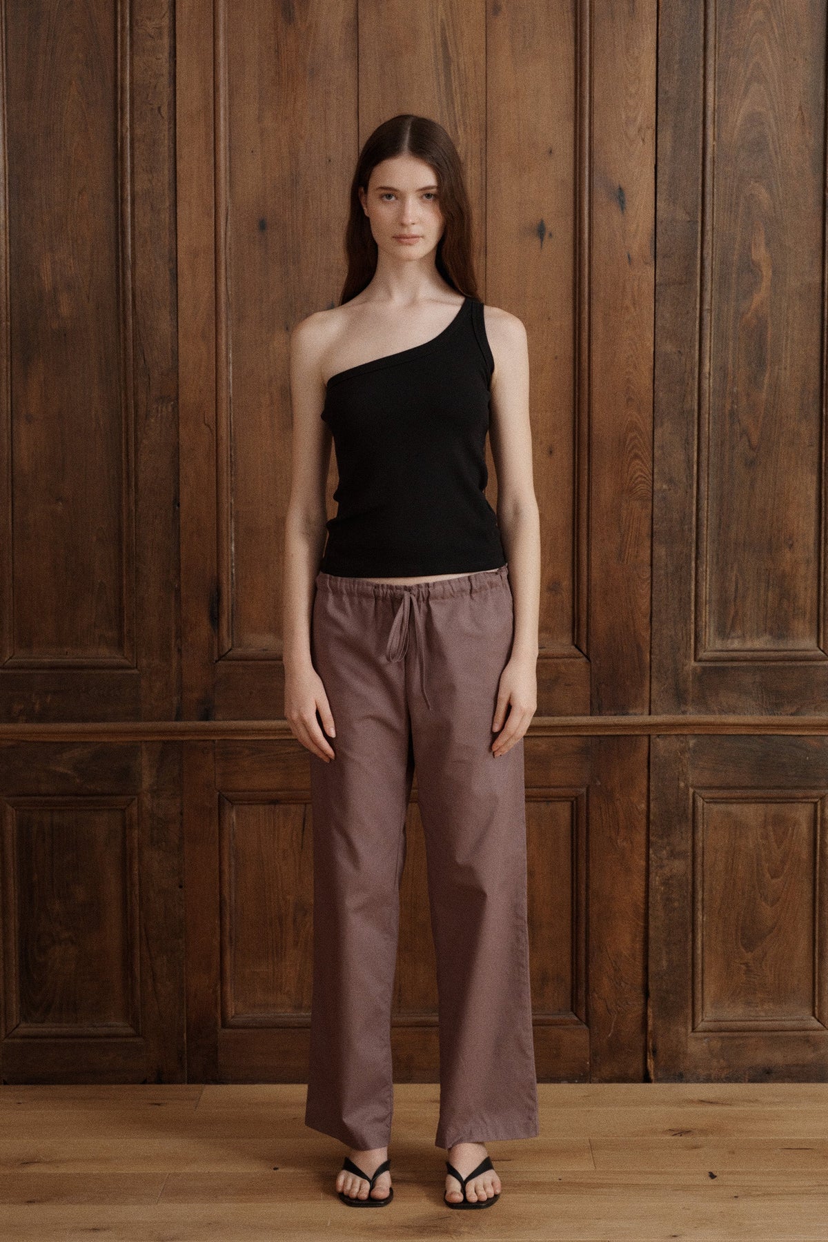 Minimalist black one-shoulder tank with an asymmetrical neckline and sleek fitted shape. - VIR VITA
#color_Black
