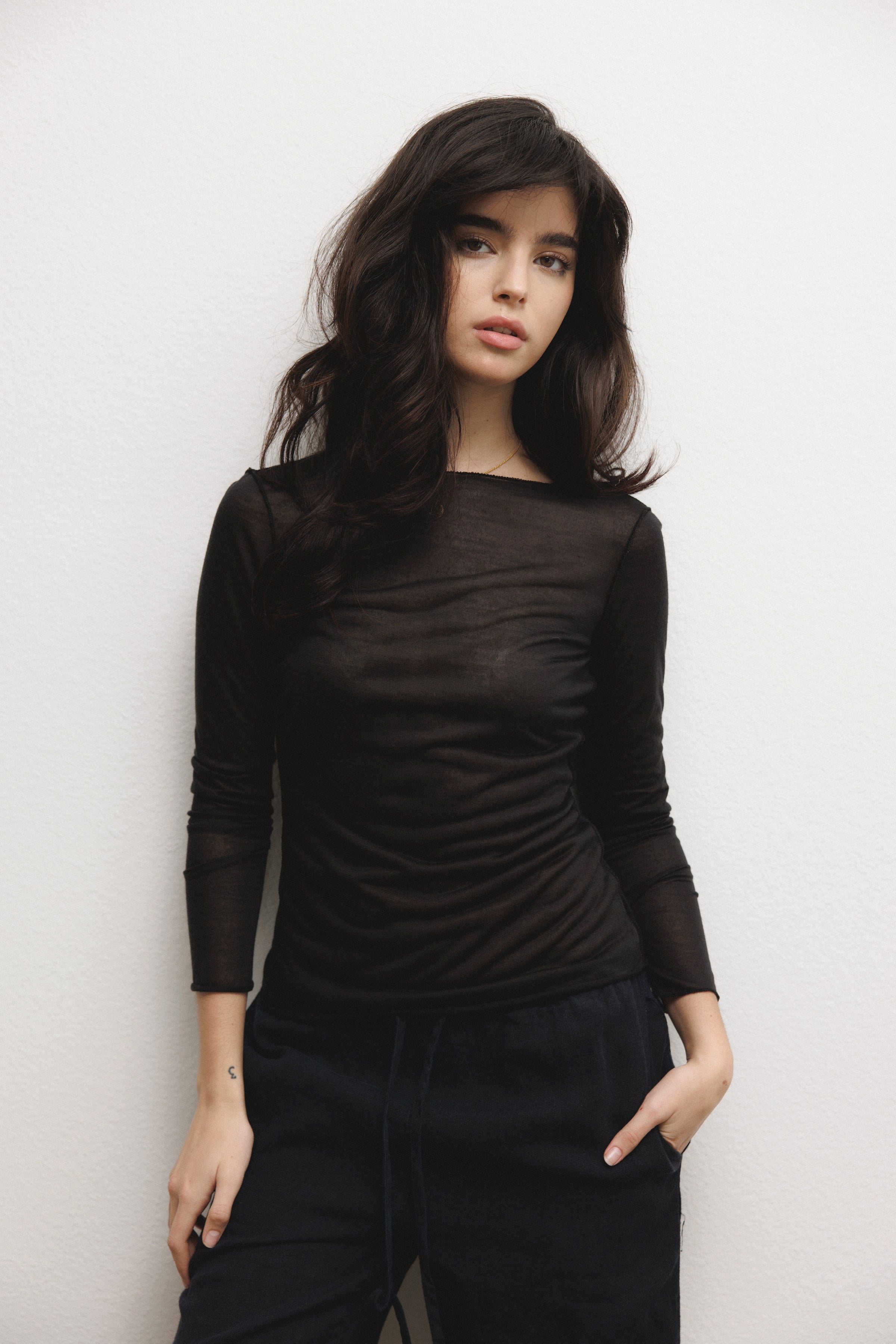 Female model wearing black modal silk long sleeve knit with a ribbed back- VIR VITA
#color_black