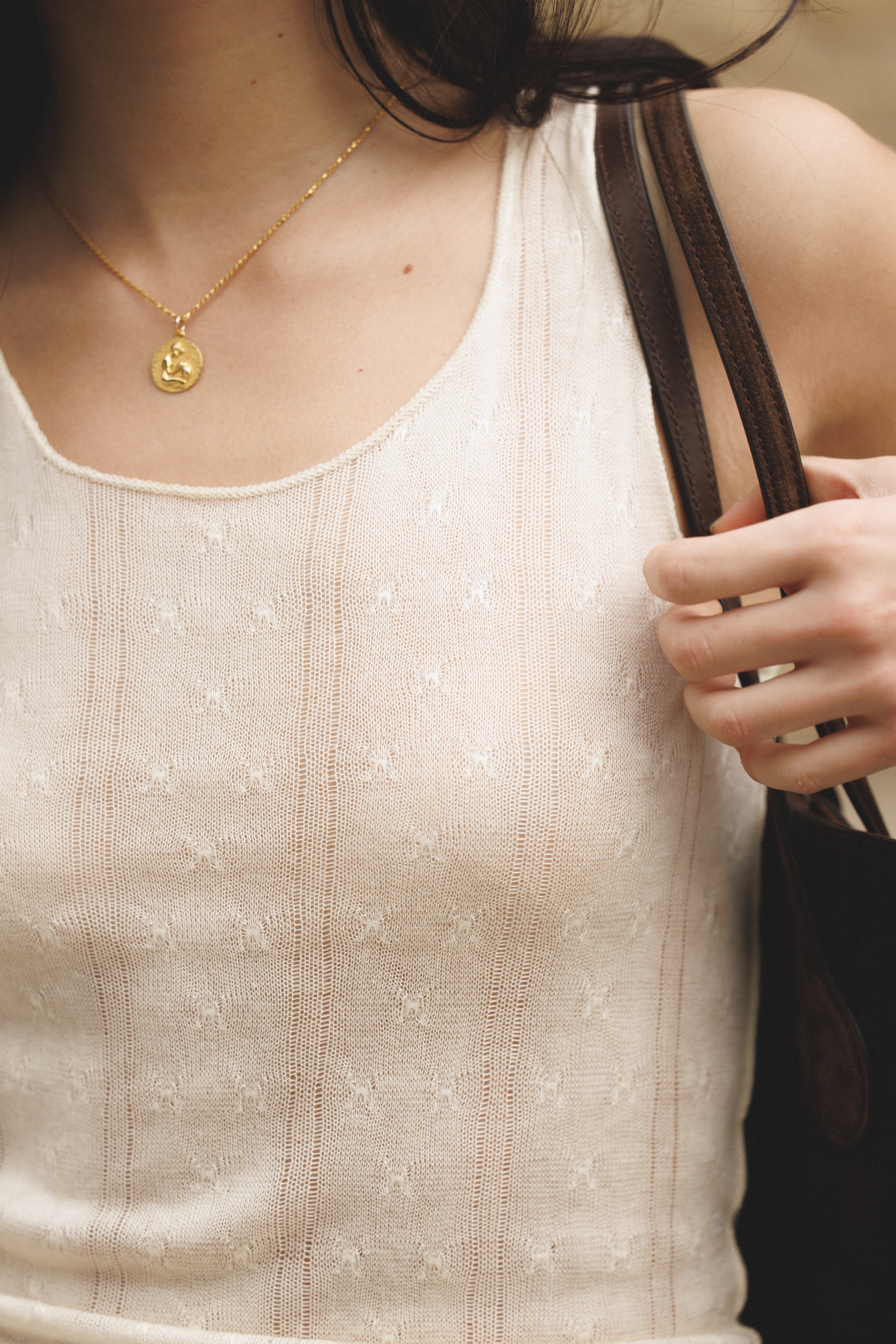 female model wearing cream cashmere knit tank top woven in italy 15 years ago. This is a sustainable dead stock fabric in a unique pointelle design - VIR VITA
#color_cream