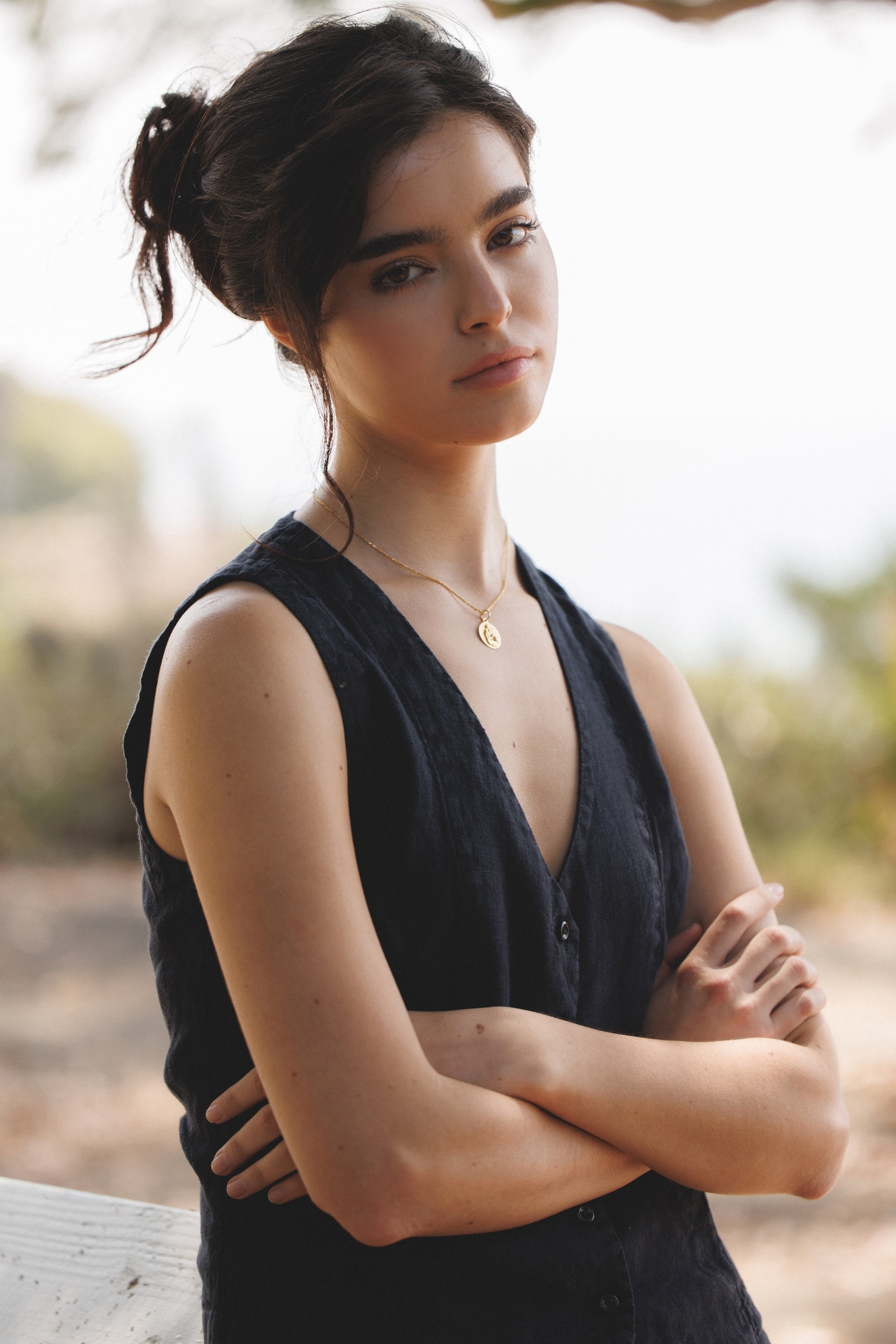 Female model,  wearing a black colored sustainable linen vest  with black linen mini skirt- VIR VITA
#color_black