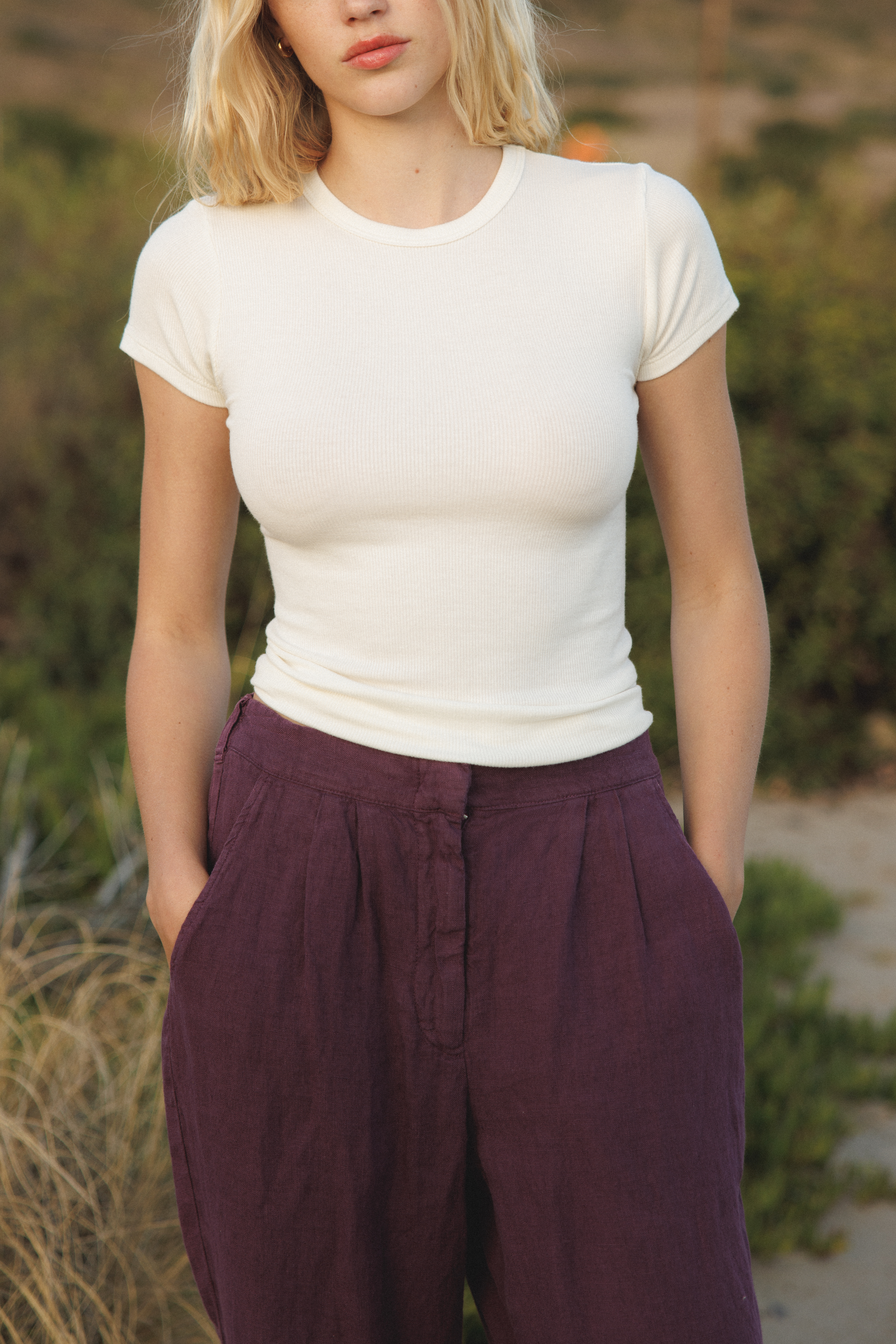 Female model wearing a sustainable white fitted tee in the color coconut - VIR VITA
#color_coconut