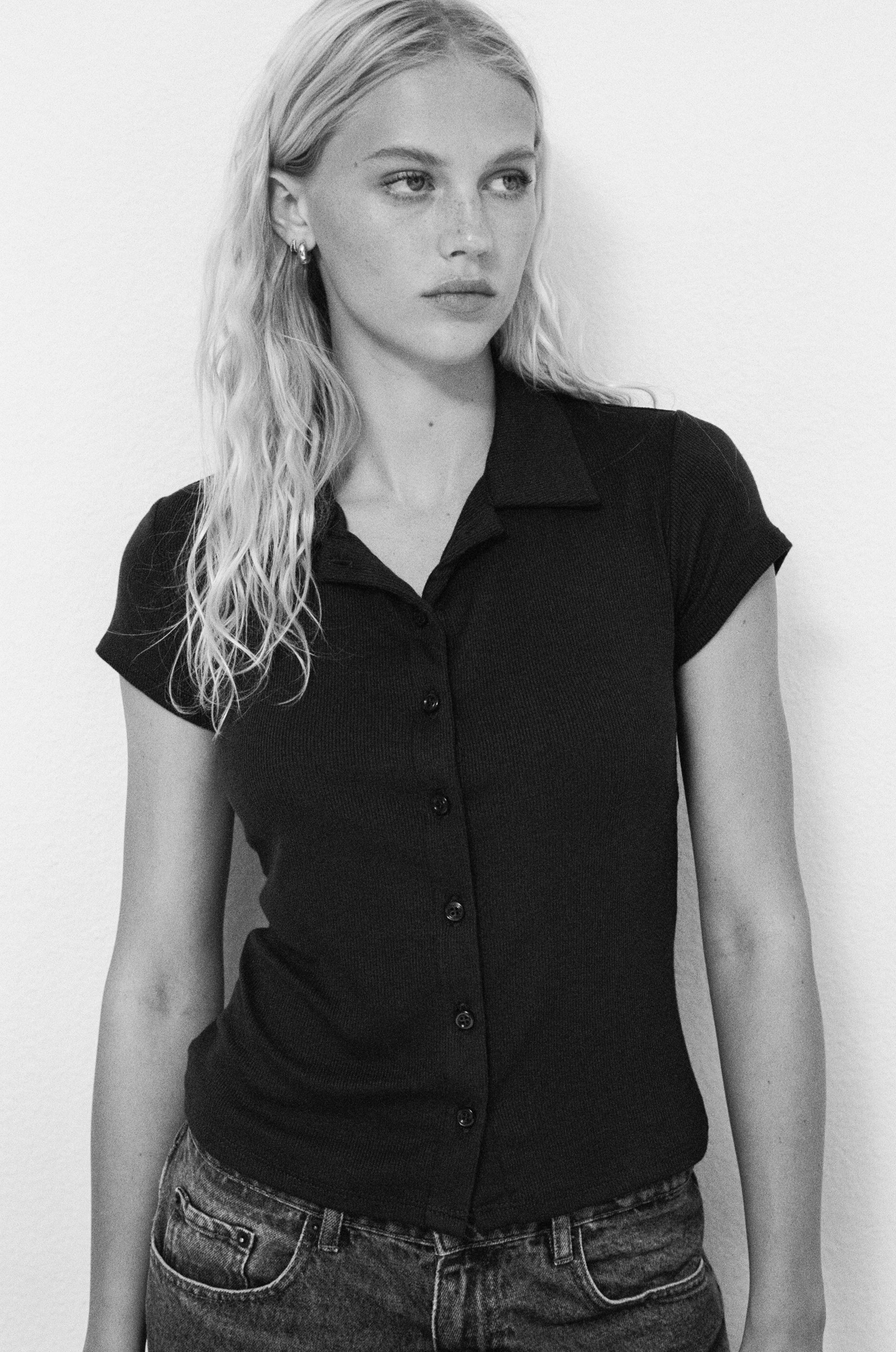 Female model wearing navy sustainable micro modal short sleeve ribbed polo top with italian button detailing. Classic, timeless, elegant, french style. Natural organic clothing - VIR VITA


navy polo ribbed top 