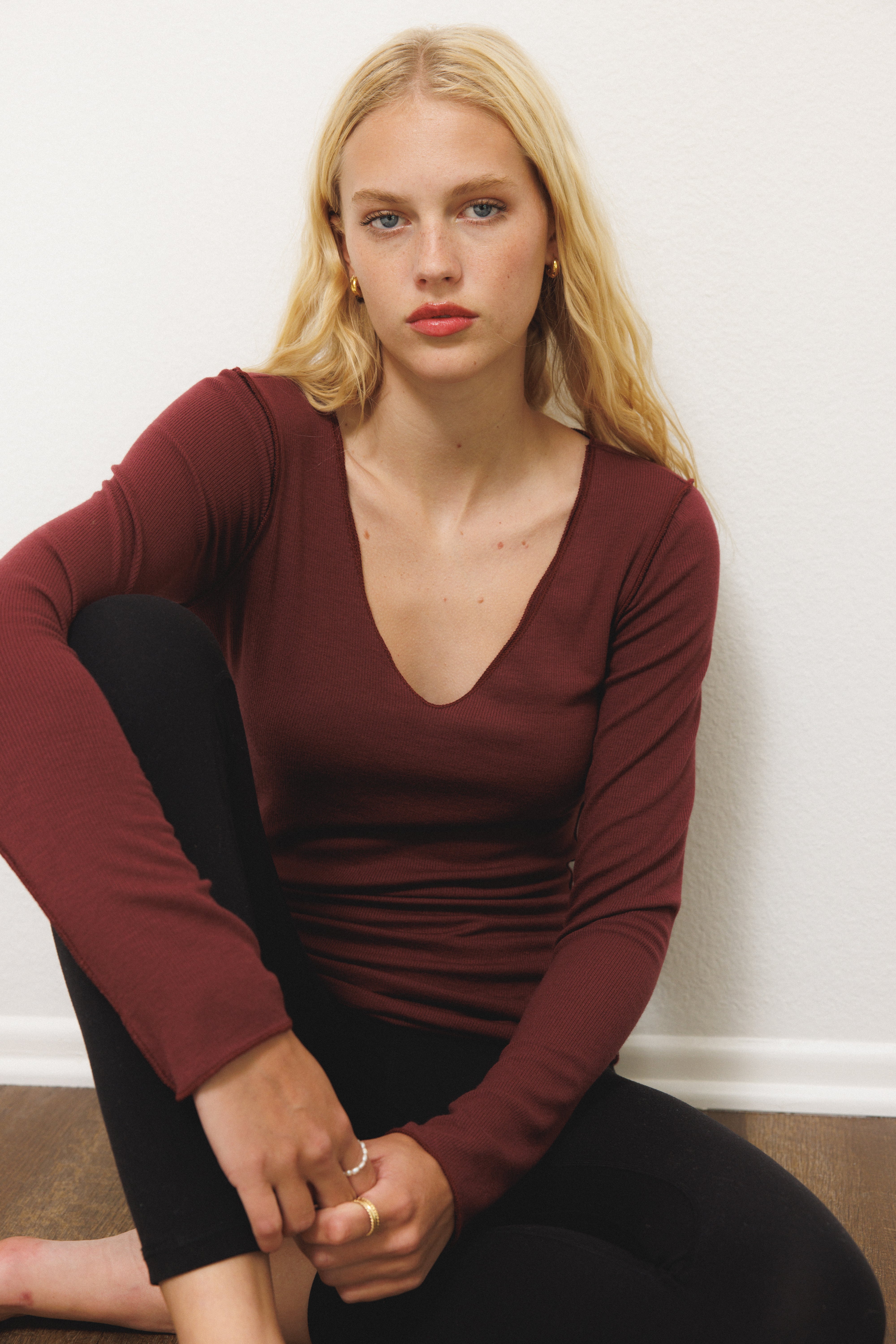 Female model wearing sustainable micro modal maroon buttery soft double lined v neck long sleeve ribbed top. Classic, timeless, elegant, french style. natural organic clothing- VIR VITA

#color_maroon