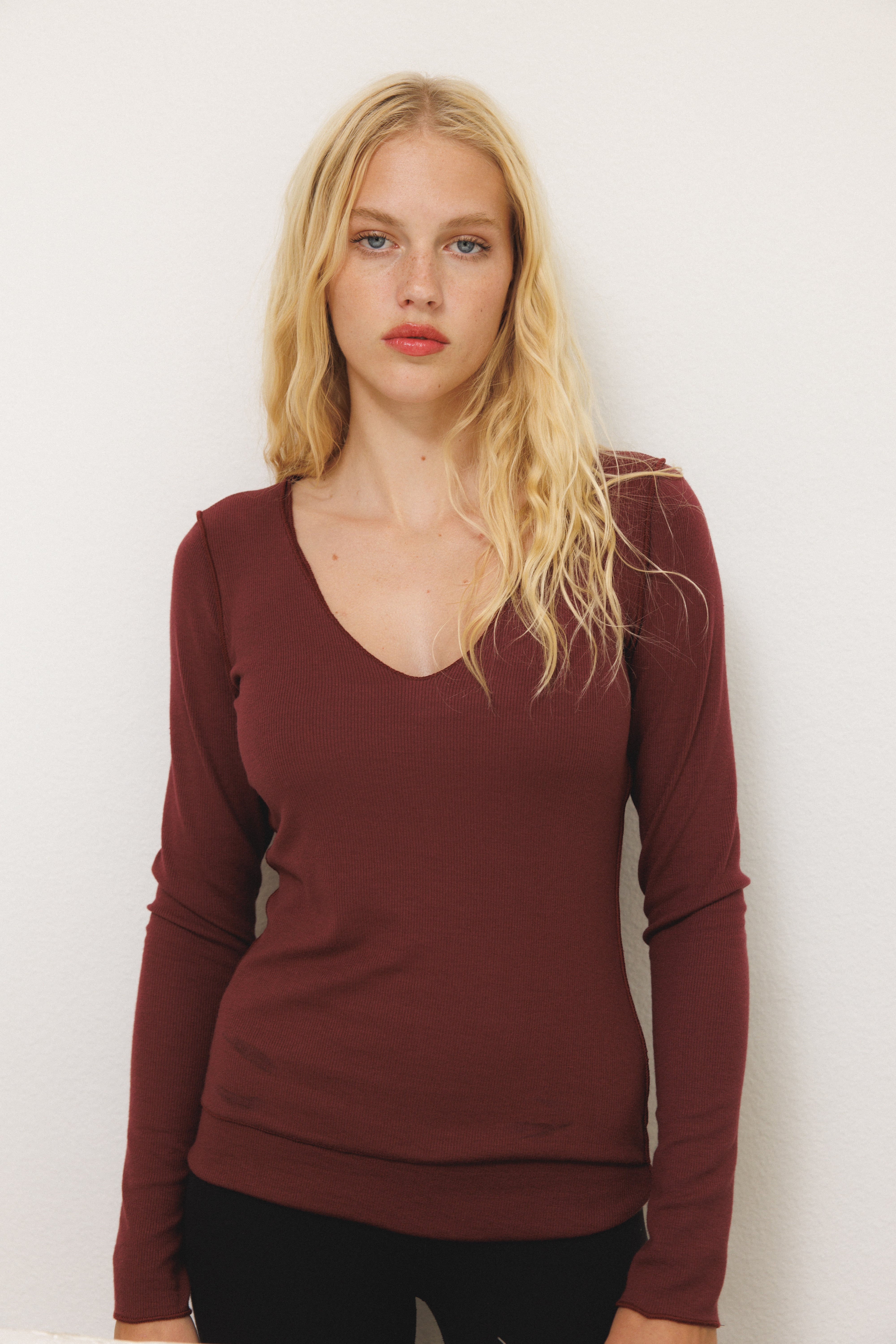 Female model wearing sustainable micro modal maroon buttery soft double lined v neck long sleeve ribbed top. Classic, timeless, elegant, french style. natural organic clothing- VIR VITA

#color_maroon